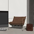 Brown Velvet Lounge Chair With Metal Frame And Matching Ottoman In Modern Interior Space