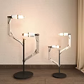 Modern Three Floor Lamps With Minimalist Metal Frame And White Lamp Heads In Indoor Living Space