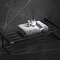 Modern Bathroom Accessories with Black Towel Rack Gray Towel Reed Diffuser on Dark Marble Wall