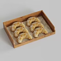 Perfectly Arranged Fresh Croissants Dusted with Powdered Sugar in Wooden Tray
