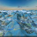 Rolling Mountains With Blue Yellow Orange Hues And Trees Under Blue Sky At Sunset