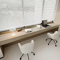 Modern desk and white chair set with laptop books and table lamp by window