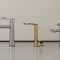 Three Modern Water Faucets in Silver and Gold Finishes on Light Countertop