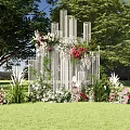 Outdoor Decorative Structure With White Columns And Colorful Flowers On Green Grass