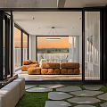 Modern Living Room Interior With Brown Sofa And Floor To Ceiling Windows