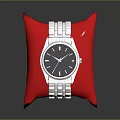 Elegant Silver Wristwatch on Red Cushion with Metal Strap and Classic Dial Design