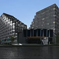 Modern Commercial Street With High Rise Buildings Storefronts Pedestrians And Traffic Lights