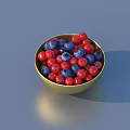 Fresh Red and Blue Berries Filled in a Golden Bowl on Blue Surface