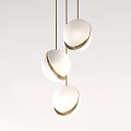 Modern Three Pendant Lights With White Spherical Shades And Gold Edges Hanging On Gold Chains