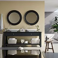 Double Sink Bathroom Vanity With Black Cabinet Two Round Mirrors Yellow Wall And Green Plant