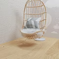 Woven Rattan Hanging Chair With Striped Pillow And Fluffy Cushion On Light Wooden Floor