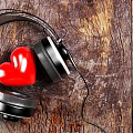 Stylish Black Headphones With Red Heart Placed On Vintage Wooden Surface