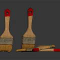 Wooden Paintbrushes With Red Handles And Yellow Bristles On Dark Surface