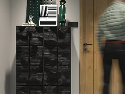 Black Chest of Drawers With Decorative Items on Top Next to Wooden Door 3d model