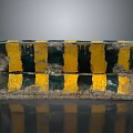 Worn Concrete Road Barrier With Yellow And Black Stripes For Traffic Safety