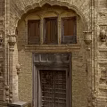 Traditional Stone Entrance Gate With Arched Top Intricate Carvings And Decorative Elements