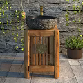 Rustic Stone Washbasin On Wooden Stand With Green Plants And Stone Wall