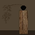 Black Vase With Twigs And Small Berries On Wooden Pillar Against Light Wall With Shadows