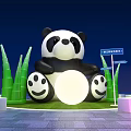 Panda Themed Photo Check In Spot with Green Bamboo Plants and Illuminated Signposts at Night