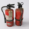 Two Old Red Fire Extinguishers With Black Nozzles And Metal Straps
