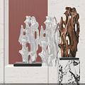 Abstract Modern Sculptures With Silver And Brown Carvings On Marble Bases Against Striped Wall