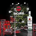 Bacardi Product Display Setup With Bottles Red Elements Speakers And Green Plants
