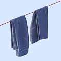 Two Dark Blue Clothes Hanging On Clothesline Drying Outdoors In Daylight