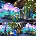 Jellyfish Shaped Floral Installation With Purple Pink Blooms Green Trees And Lighting In Mall Atrium