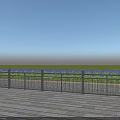 Metal Fence With Vertical Bars On Wooden Deck Overlooking Green Grass And Blue Sky