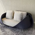 Unique Curved Fabric Sofa With Dark Frame And Light Cushions In Modern Living Room
