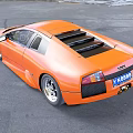 Orange Sports Car With Sleek Aerodynamic Design And Black Accents
