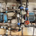 Industrial Mechanical Pipes System With Blue Pumps Valves And Motors In Workshop Facility