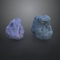 Two Purple And Blue Perforated Rockery Stones Placed On Dark Surface