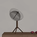 Stylish Silver Table Lamp with Hemispherical Perforated Shade and Tripod Metal Stand on Wooden Desk