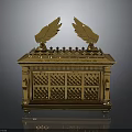 Golden Ornate Chest With Wing Decorations And Intricate Carved Patterns On Reflective Base