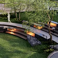 Serene Park Landscape With Lush Green Grass Curved Pathway Trees And Stone Benches