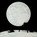 Round Rug With Alphabet Pattern In Cozy Room With Chair And Floor Lamp
