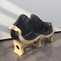 Modern Public Chair With Curved Design Black Leather Seat And Golden Legs On Wooden Floor