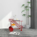 Red Modern Side Table With Wheels Holding Oranges Books And Green Plant