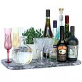 Assorted Wine Bottles And Glasses On Marble Tray With Green Plant Decoration