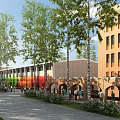 School Buildings with Rainbow Colored Sections Brick Arched Doorways and Trees Where People Walking