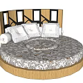 Modern Round Bed With Wooden Headboard Black Accents Patterned Bedspread And White Pillows