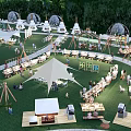 Scenic Camping Site With Green Grass Tents Outdoor Dining And Relaxation Spaces