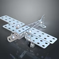 Metallic Toy Airplane Model With Holes And Assembled Metal Pieces On Dark Background