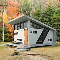 Modern Concrete Single Family House With Sloped Roof Large Windows Autumn Trees And Outdoor Seating