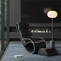 Black Leather Lounge Chair In Modern Living Room With Floor Lamp And Fireplace
