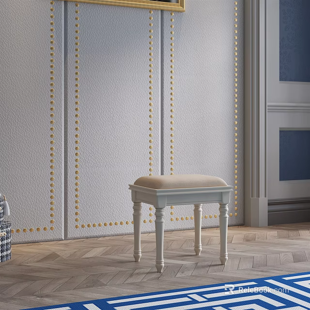 Upholstered Beige Cushion Stool With White Legs Against Gold Nailhead Trim Wall And Wooden Floor 3d model 
