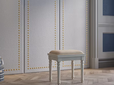 Upholstered Beige Cushion Stool With White Legs Against Gold Nailhead Trim Wall And Wooden Floor 3d model
