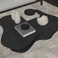 Modern Black Irregular Shape Coffee Table on Beige Rug with White Vases and Books