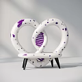 Heart Shaped Public Chair With White Body Purple Spots Intertwined Loops And Black Legs